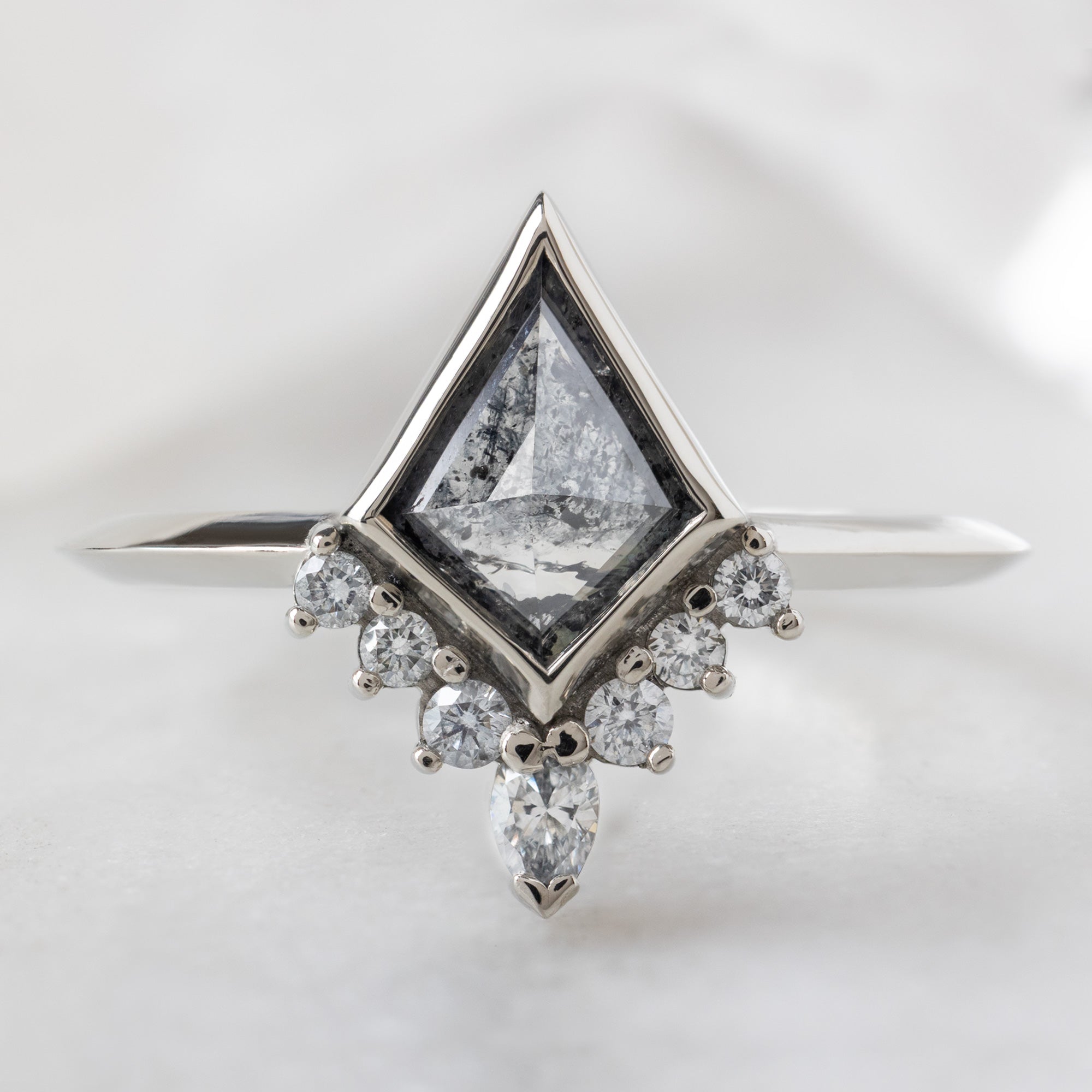 The Aster Ring with a 0.81ct Kite Salt and Pepper Diamond in 14K White Gold on White Marble