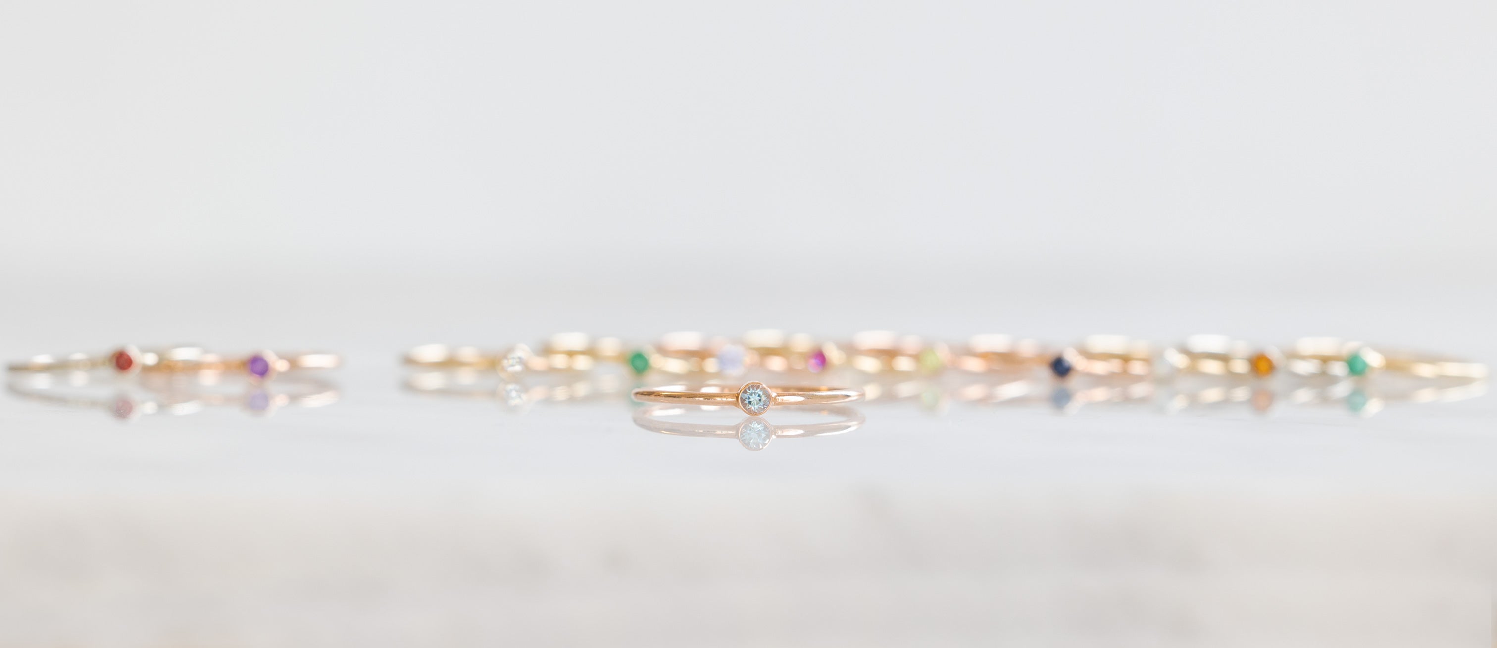 Birthstone Stacker Rings in a line with Aquamarine Stacker in the Forefront