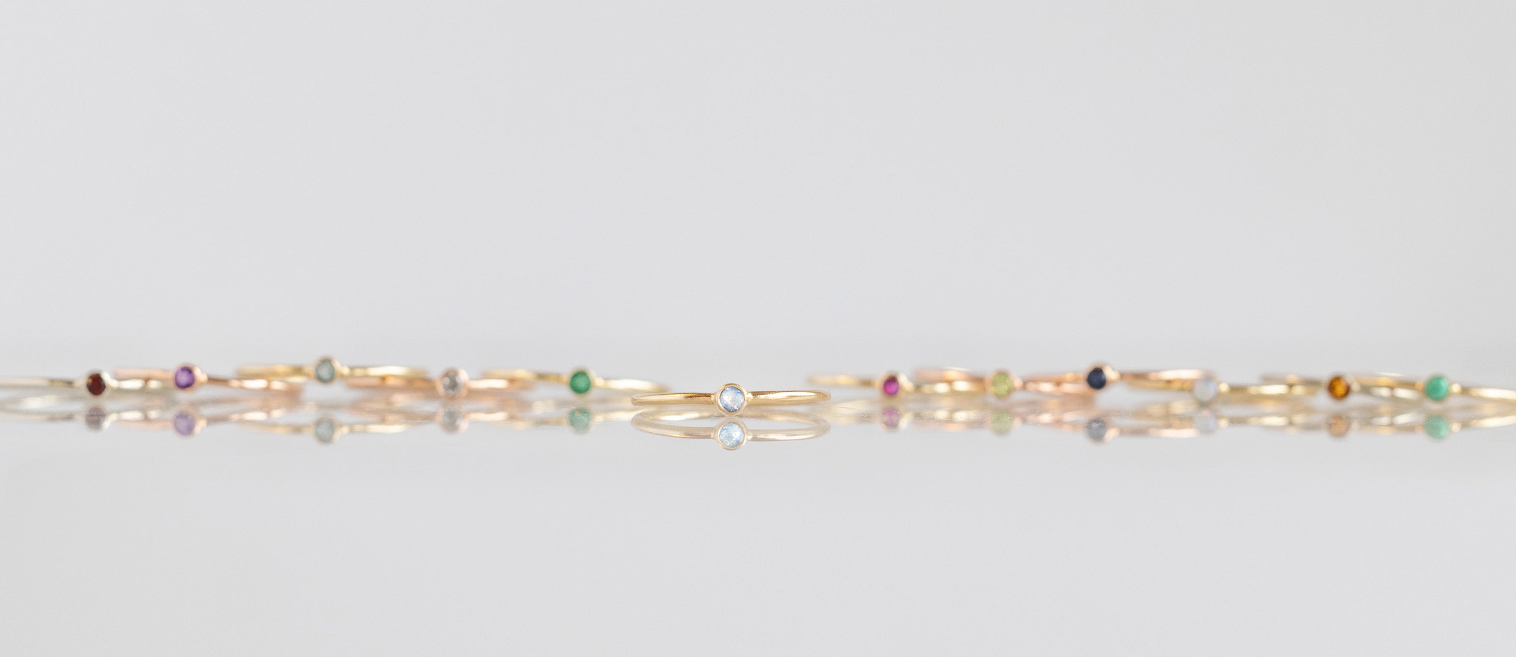 Moonstone Stacking Ring Featured with Other Birthstone Stacking Rings Behind