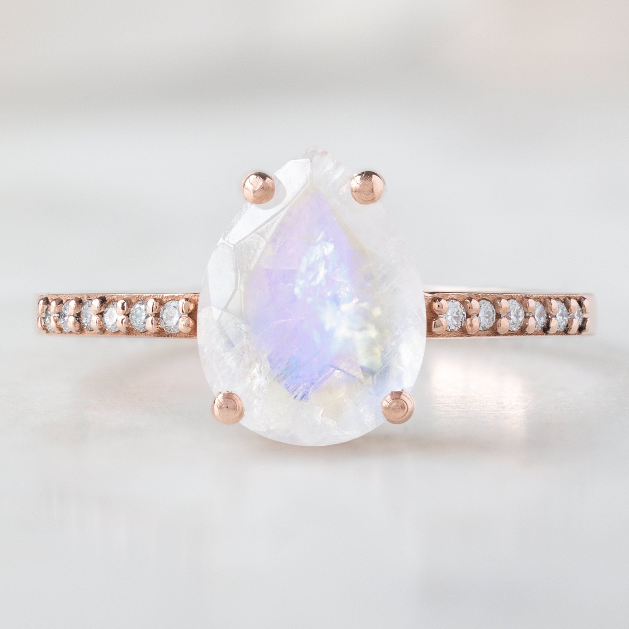 The Willow Ring with a 1.38ct Pear Moonstone in 14K Rose Gold on White Marble