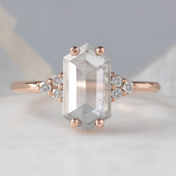 The Ivy Ring with a 1.55ct Hexagon Icy White Diamond in 14K Rose Gold on White Marble